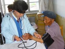 A participant in CGH's international exchange program takes a patient's blood pressure