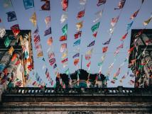 Colorful flags hang off of a church