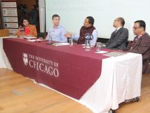 Multiple people seated at a table for a panel discussion