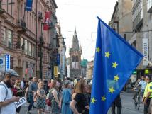 EU Flag with people walking by