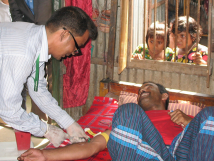 A doctor treating a man at home