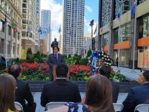 A speaker addresses an outdoor crowd at the Plaza de las Americas in Chicago