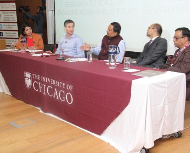 Multiple people seated at a table for a panel discussion