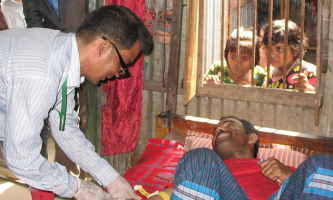 A doctor treating a man at home