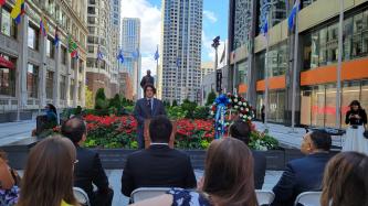 A speaker addresses an outdoor crowd at the Plaza de las Americas in Chicago