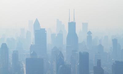 Aerial view of high-rise building covered in smog