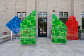 Blue, Green and Red sculptures in front of Neubauer Collegium entrance