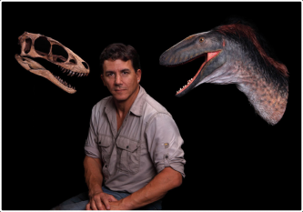 Man sitting next to dinosaur heads