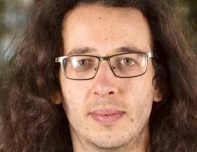 Man wearing glasses posing for a picture