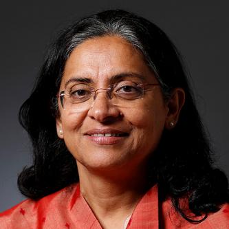 Woman wearing traditional clothes and glasses smiling for a picture